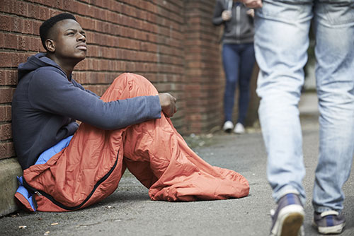 Homeless Teenage Boy BIn Sleeping Bag On The Street