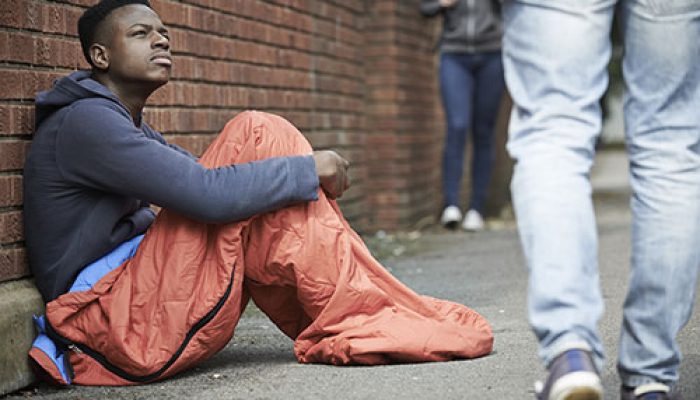 Homeless Teenage Boy BIn Sleeping Bag On The Street